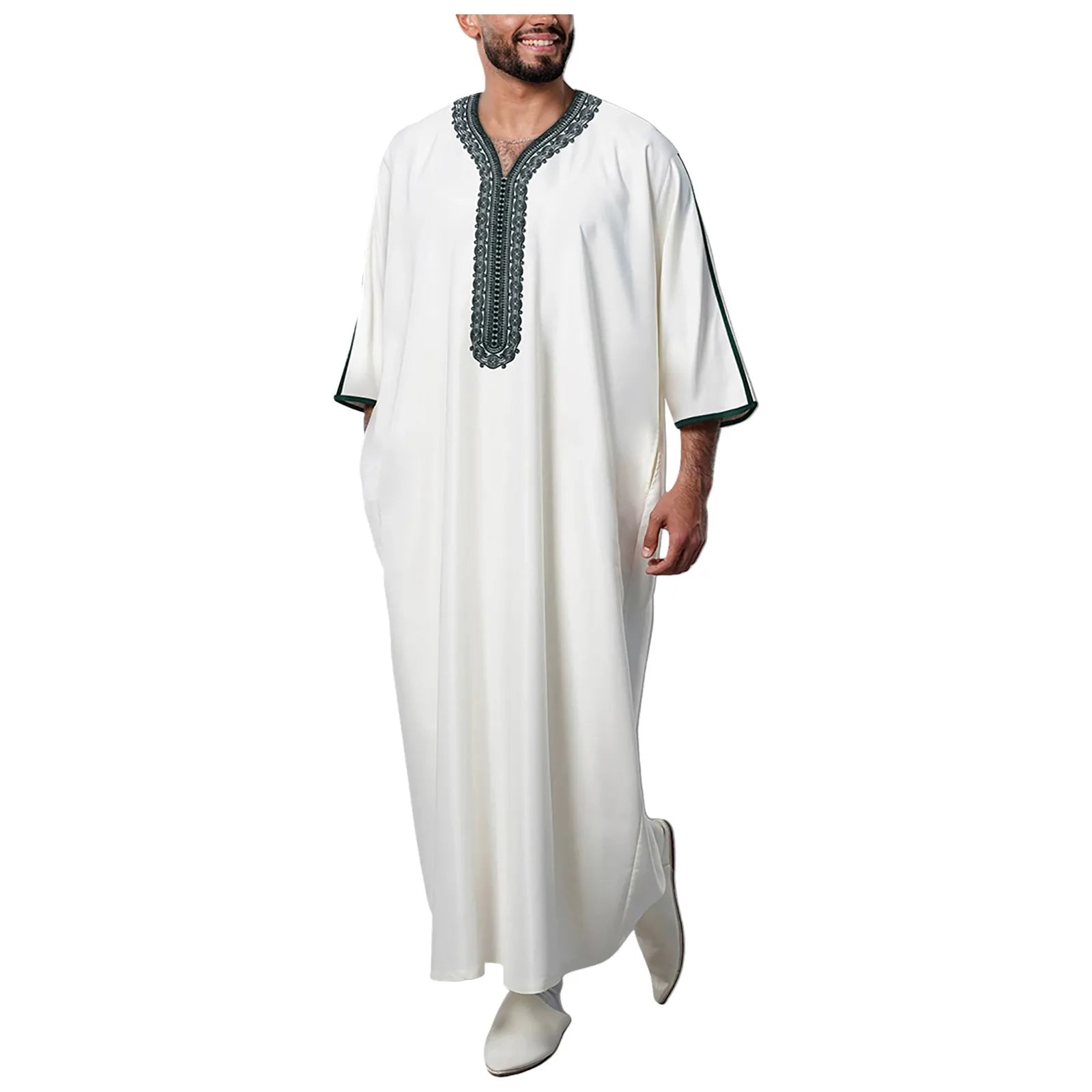 Man wearing a white embroidered robe on a white background