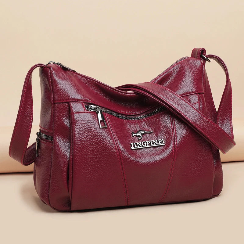 Red handbag with a visible brand logo on a beige background