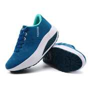 Blue sneakers with white soles on a white background