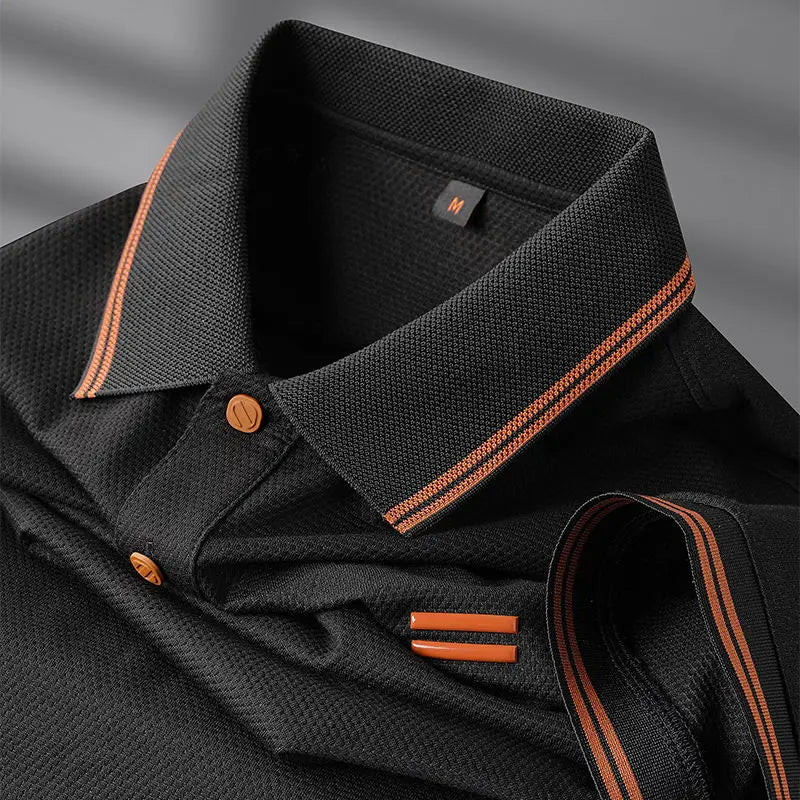 Black shirt with orange trim on a gray background