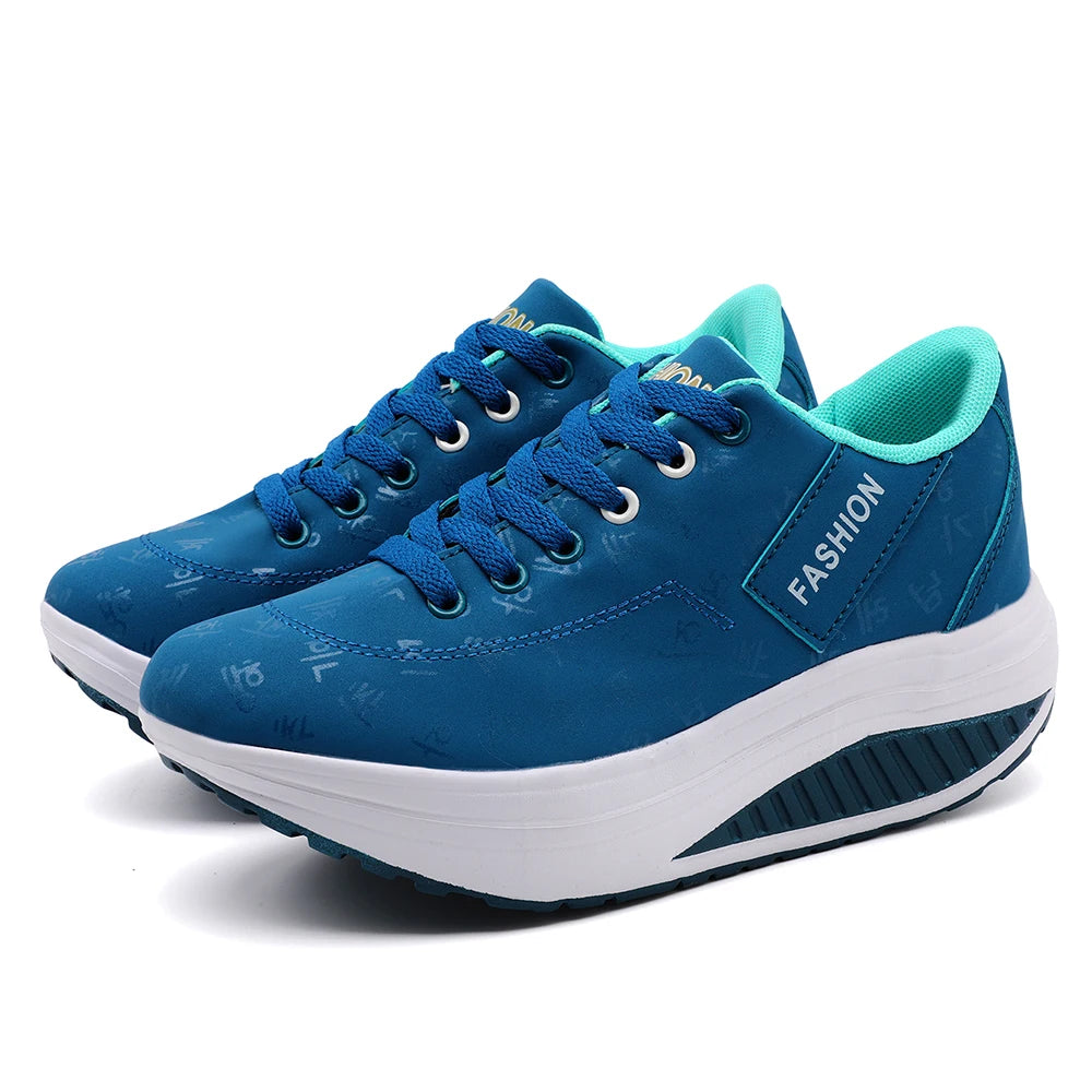 Blue platform sneakers with white soles on a white background