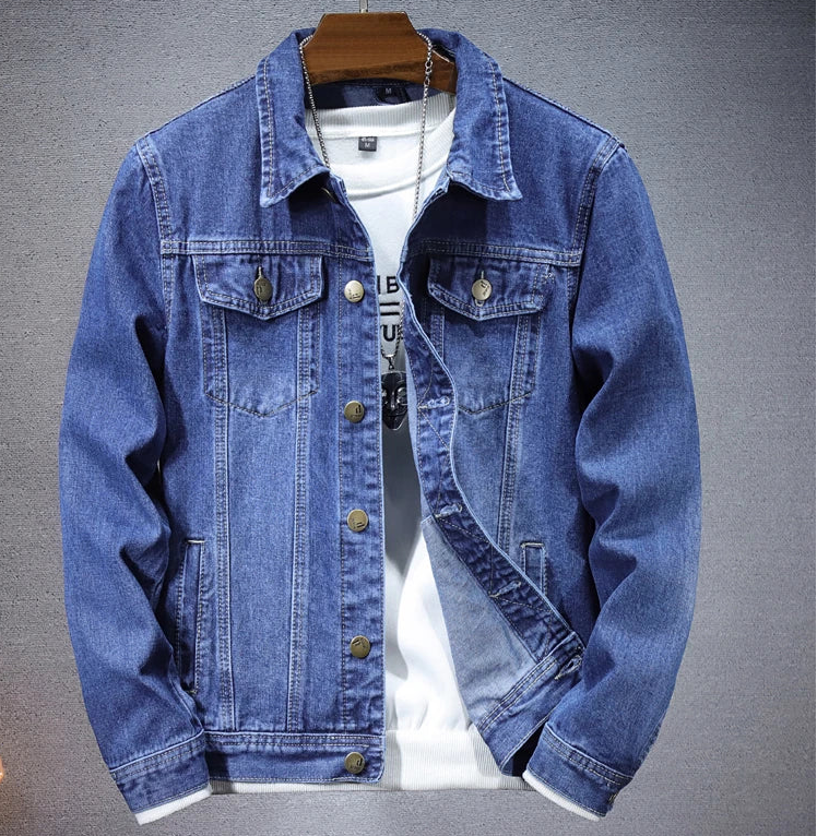 Blue denim jacket on a hanger against a gray background