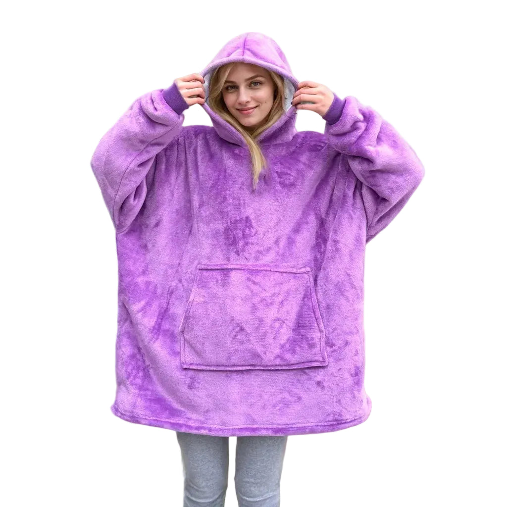 Person wearing a purple fleece poncho in a cozy indoor setting