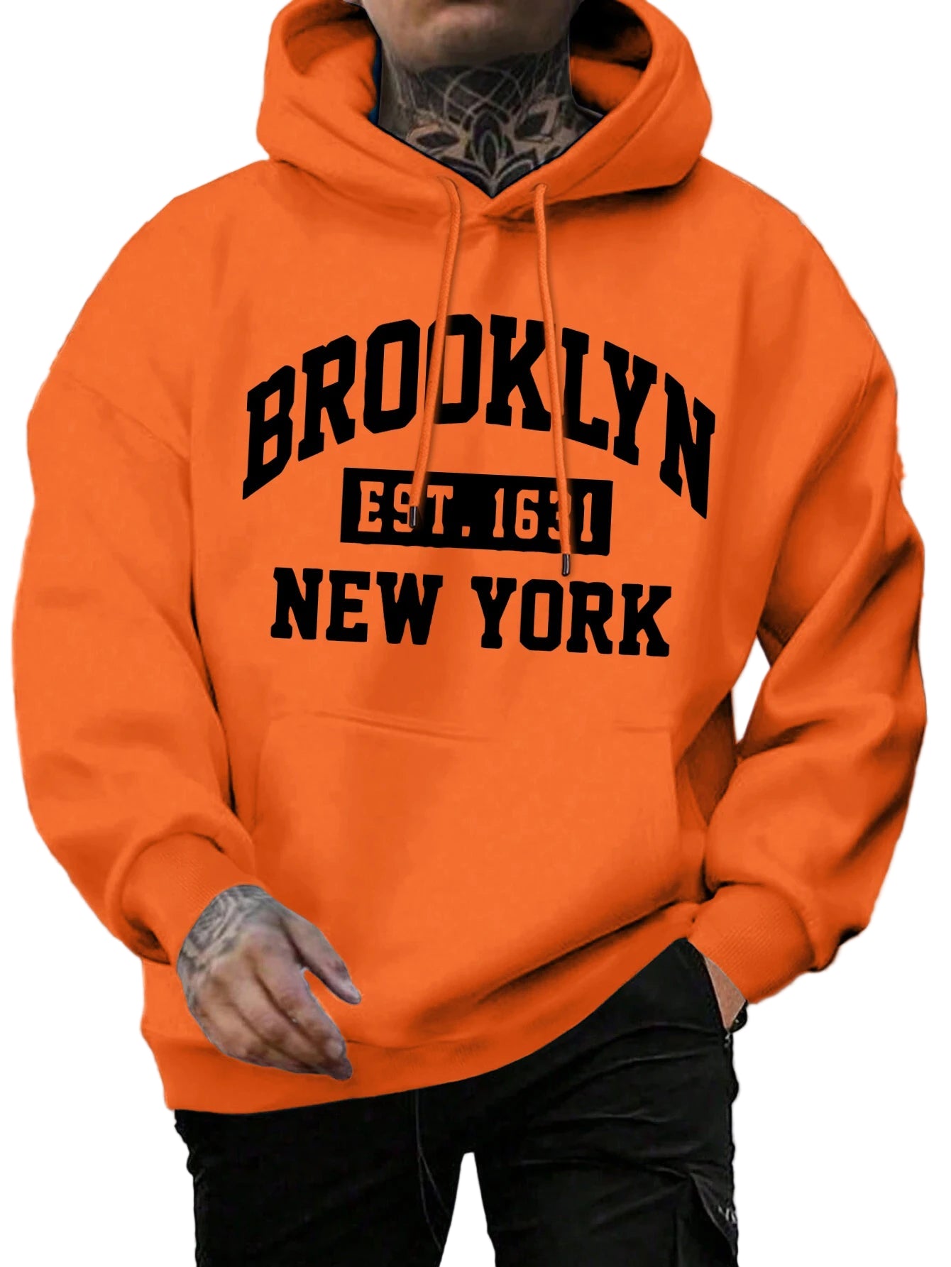 Person wearing an orange hoodie with 'Brooklyn Est. 1654 New York' text on a street background