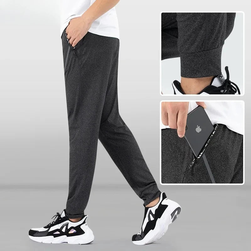 Person wearing dark gray jogger pants with inset images showing details.