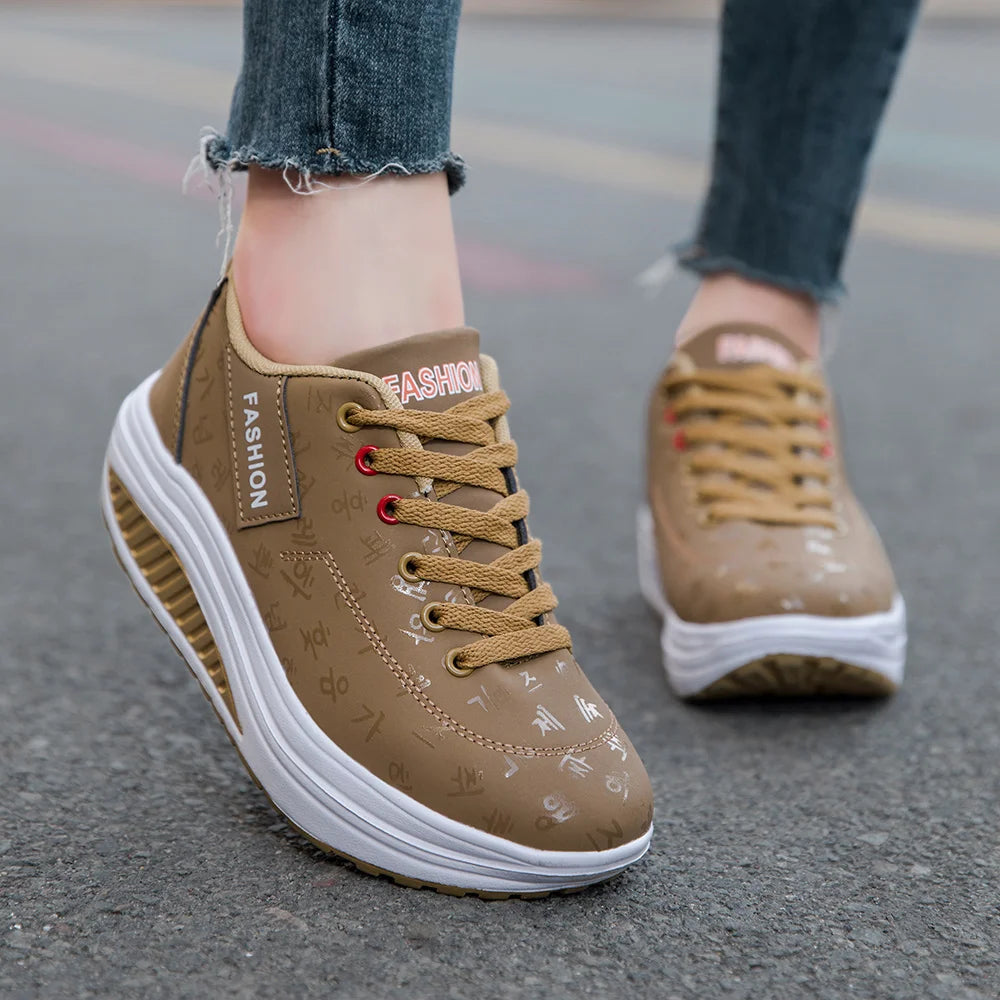 Brown sneakers with white soles on a pavement background