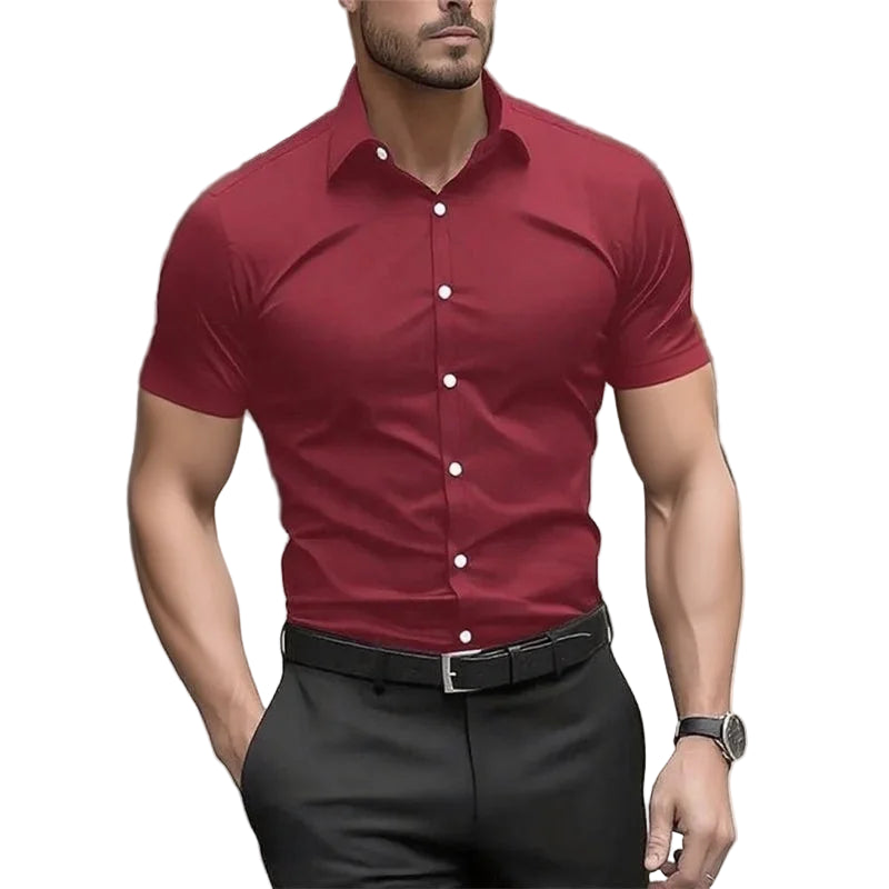 Man wearing a red short-sleeve shirt with white buttons and black pants on a blurred street background