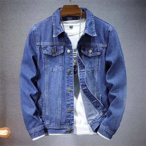 Blue denim jacket on a hanger against a gray background