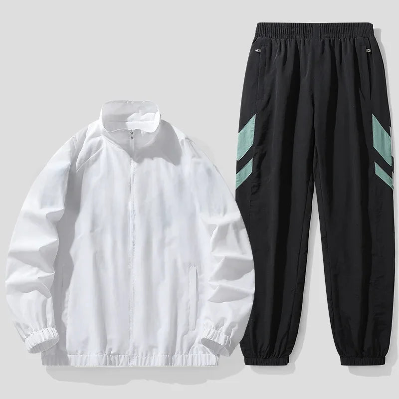 White jacket and black pants with green accents on a light gray background