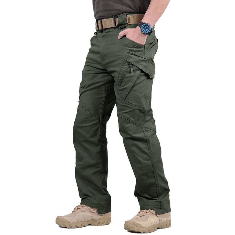 Person wearing green tactical pants on a white background