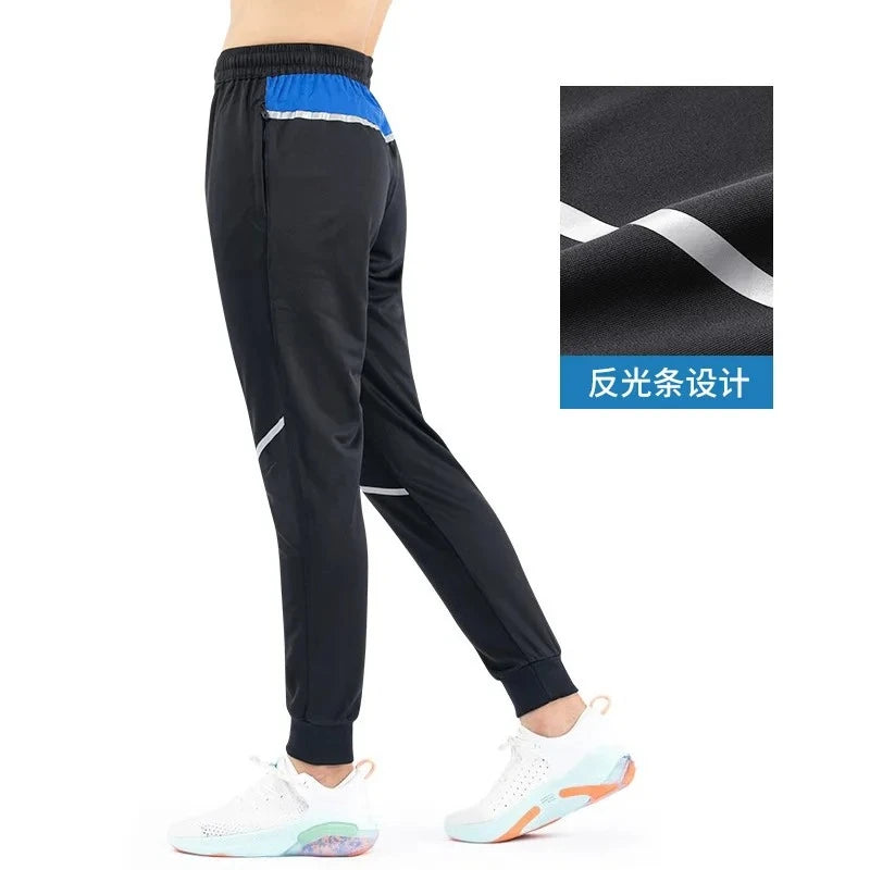 Black pants with blue and white accents on a white background
