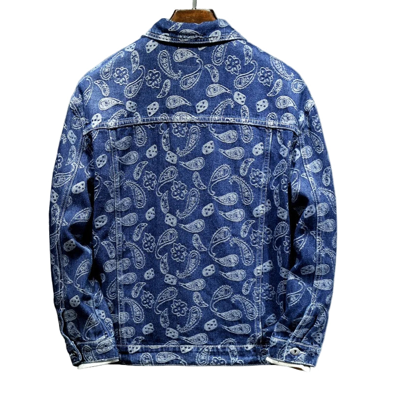 Blue denim jacket with white paisley pattern on a gray background