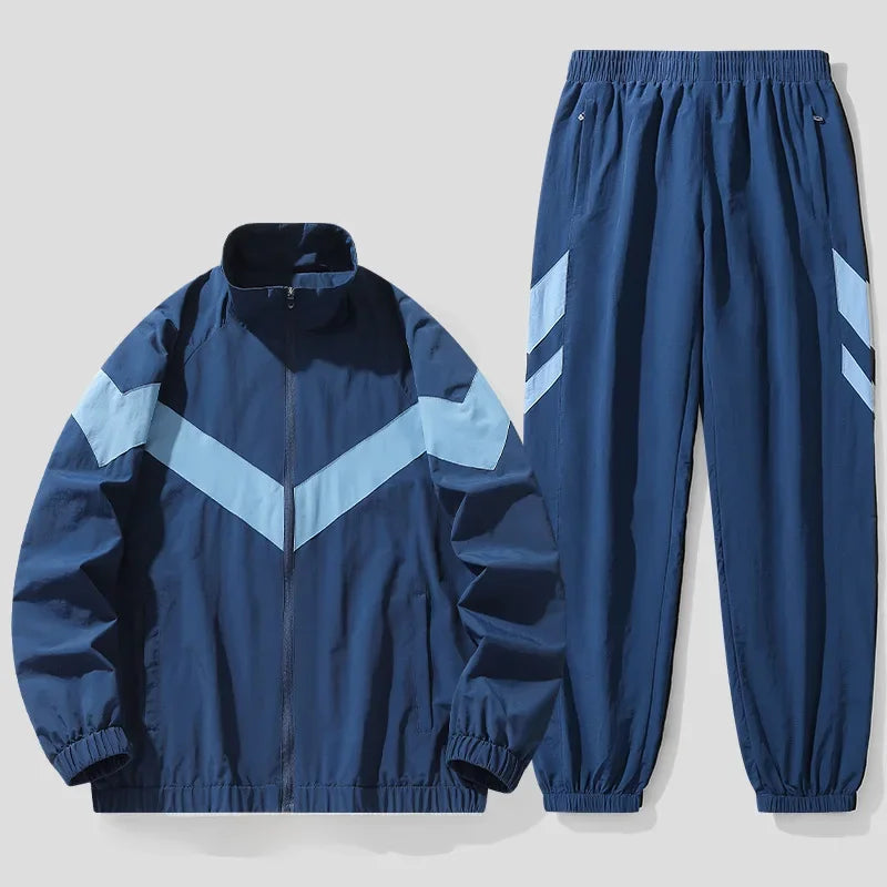 Blue tracksuit with white chevron patterns on a light gray background