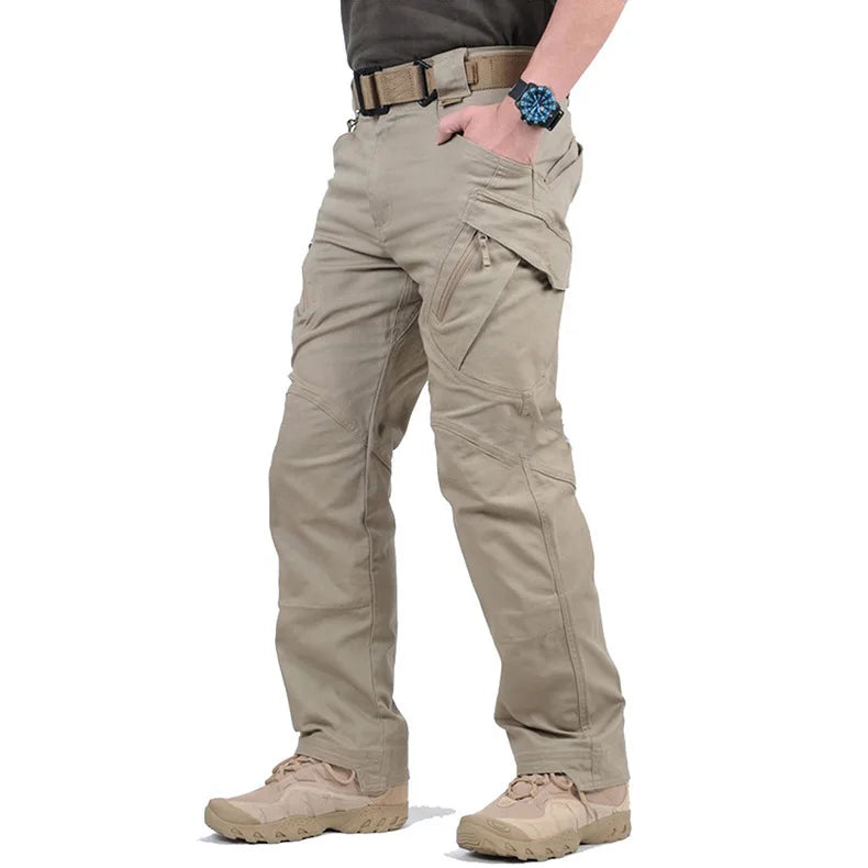 Beige tactical pants worn by a person on a white background
