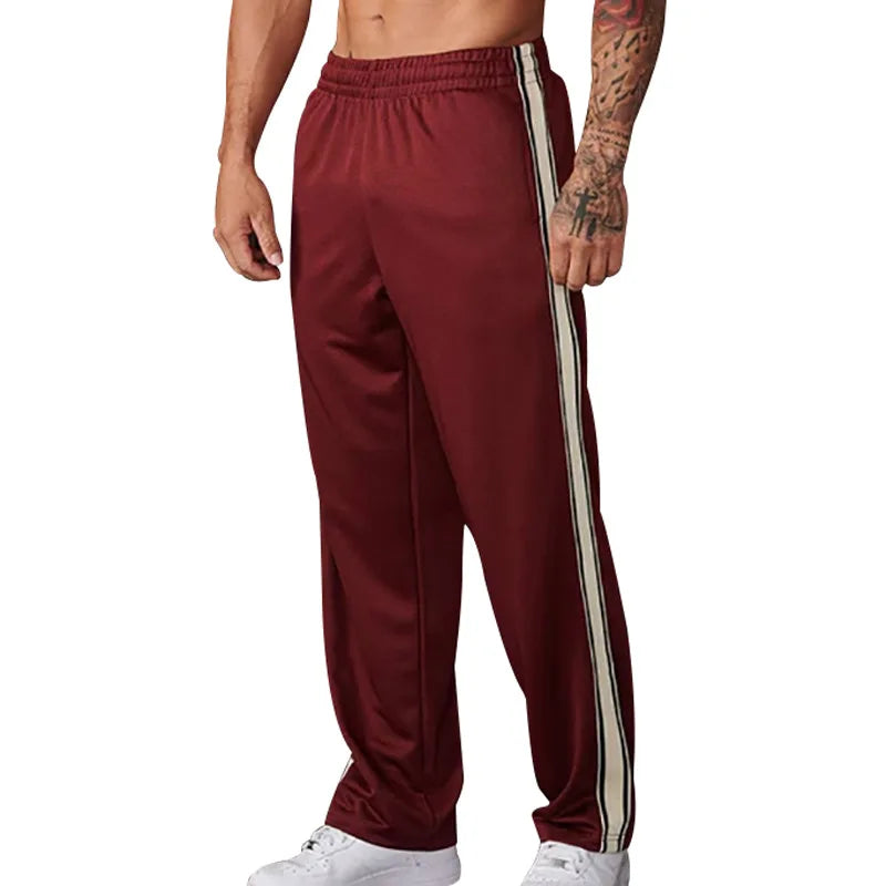 Maroon track pants with white stripes on a white background