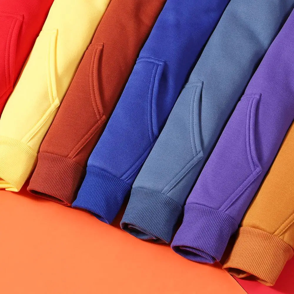 Row of colorful sweatshirts on a multicolored background
