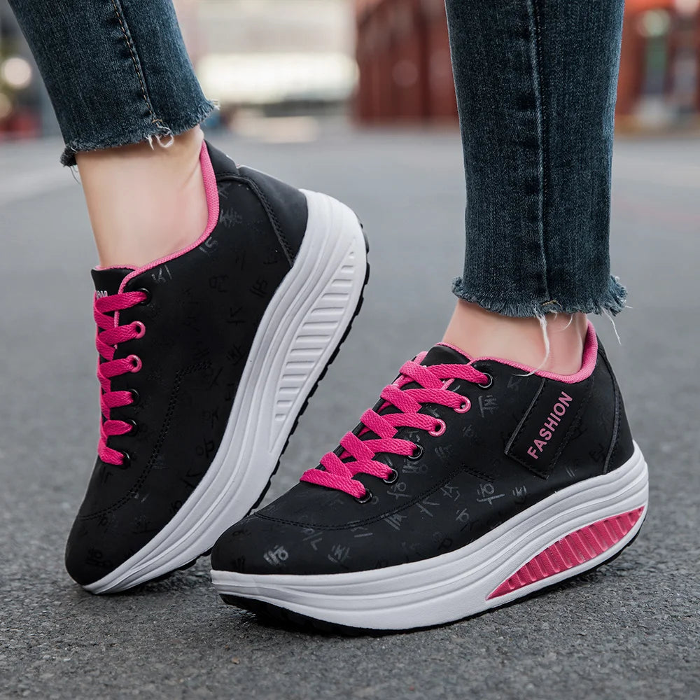 Black sneakers with pink laces and soles on a blurred street background