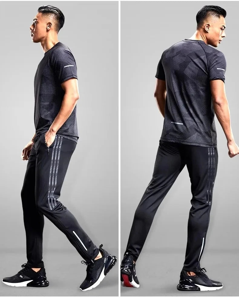 Man modeling a black athletic outfit with stripes on a gray background