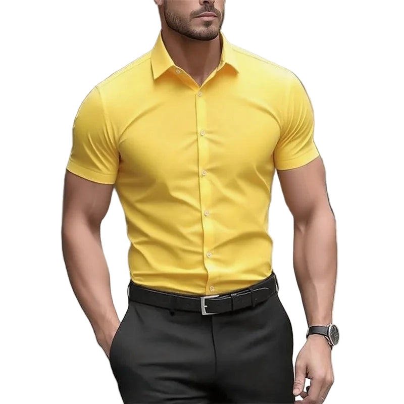 Man wearing a yellow short-sleeve shirt and black pants on a blurred street background