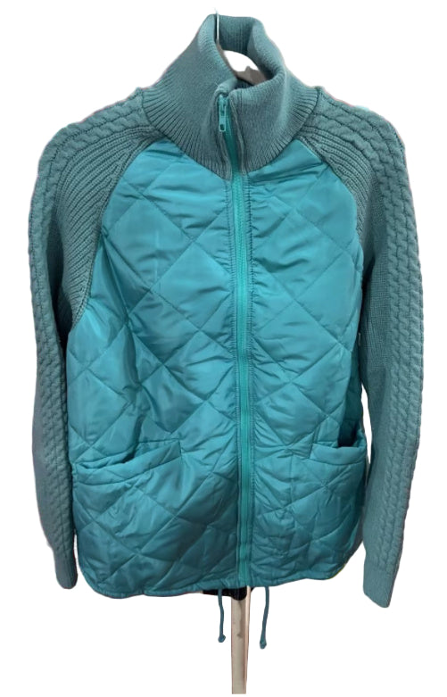 Teal quilted jacket with knitted sleeves on a hanger in a store setting